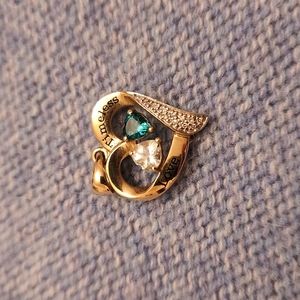 Gold charm with faux diamond and emerald accents
